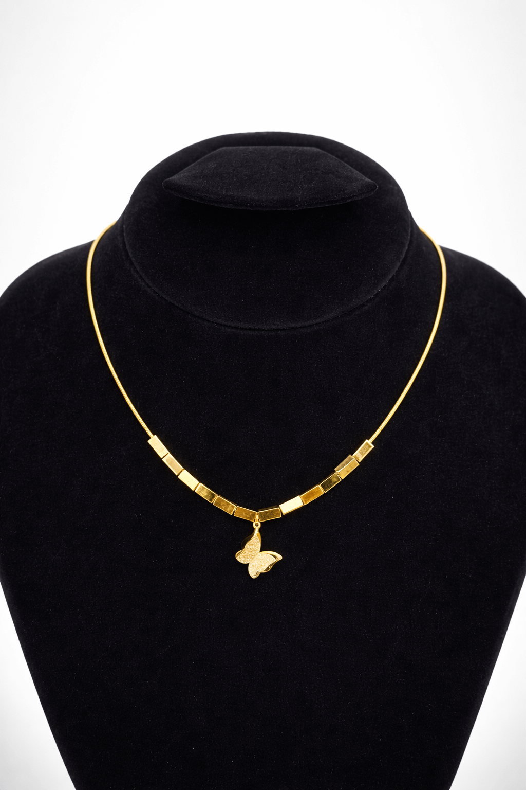 Golden butterfly bar necklace - Pakistani women's elegant jewelry with butterfly charm and geometric gold tone bar detailing front view