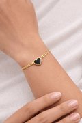 Black heart gold bracelet - Pakistani women's elegant jewelry with gold tone chain and bold black heart charm front view